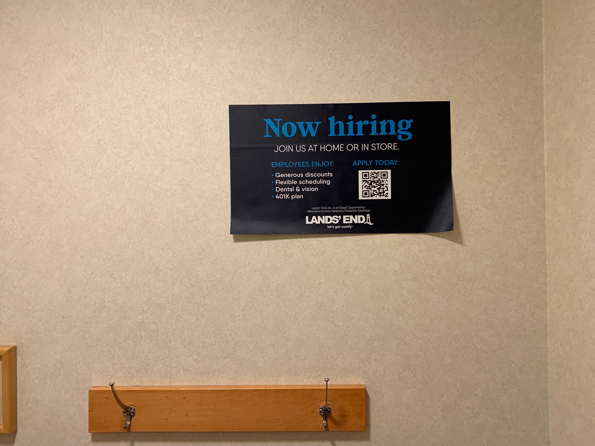 The same 'now hiring' sign on a wall, wrinkled and peeling from having been removed from the mirror and moved over here.