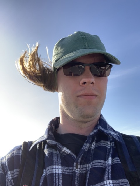Me standing with the wind at my back, ponytail flying forward in disarray on one side of my face.